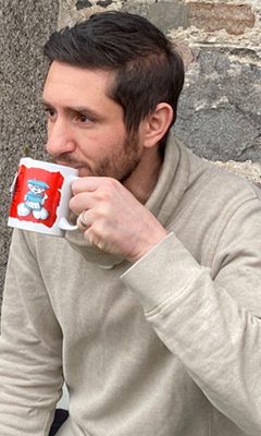 Daniel, one of the hosts, drinking from a mug